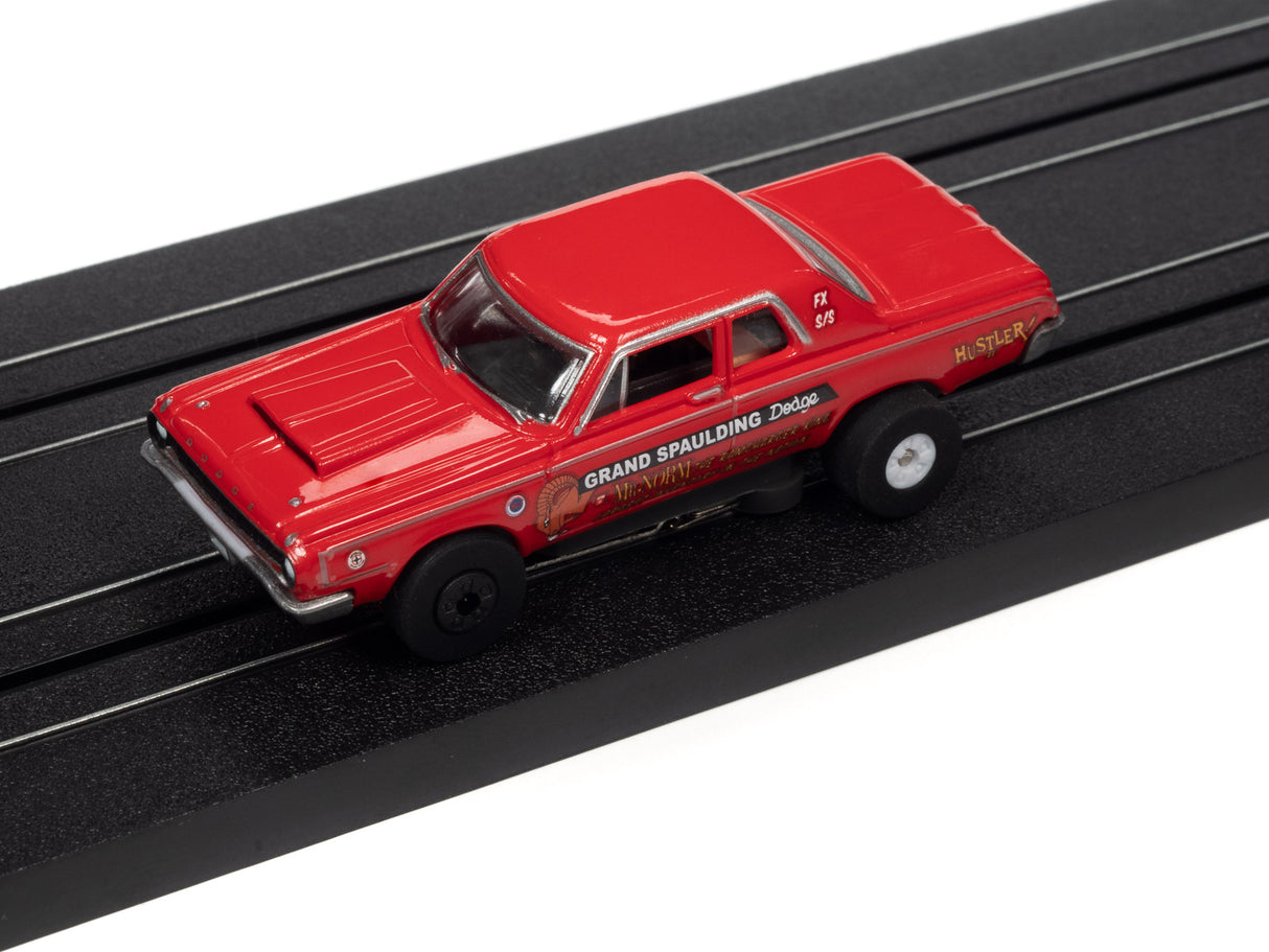Red slot car of a 1950s Grand Spaulding Dodge on a black track for Auto World SC379