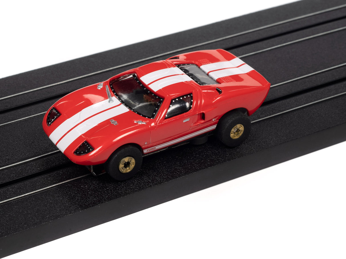 Red and white Ford Thunderjet toy car on a black track for Auto World SC379