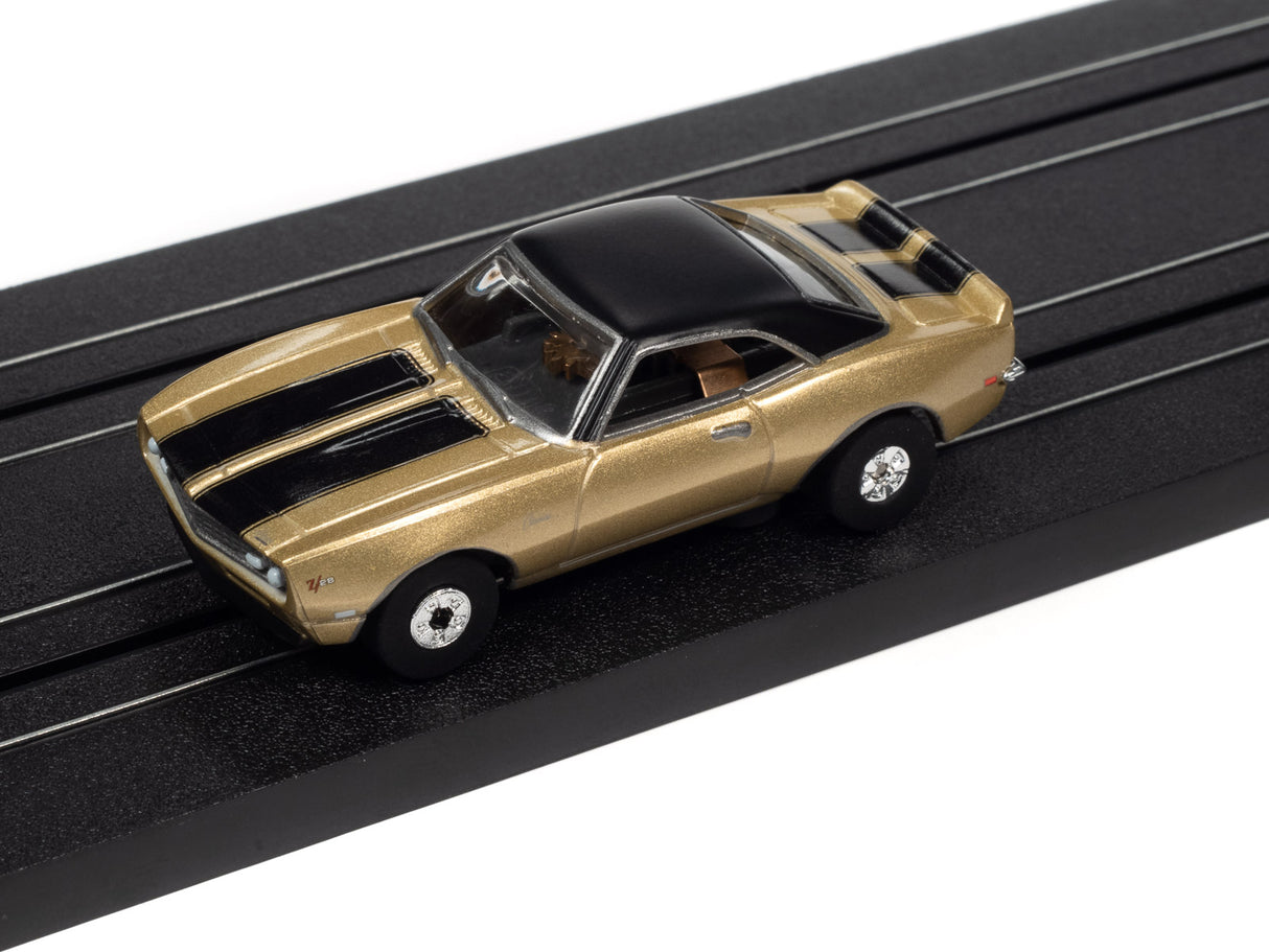 Gold and black slot car on a black track for Auto World SC379