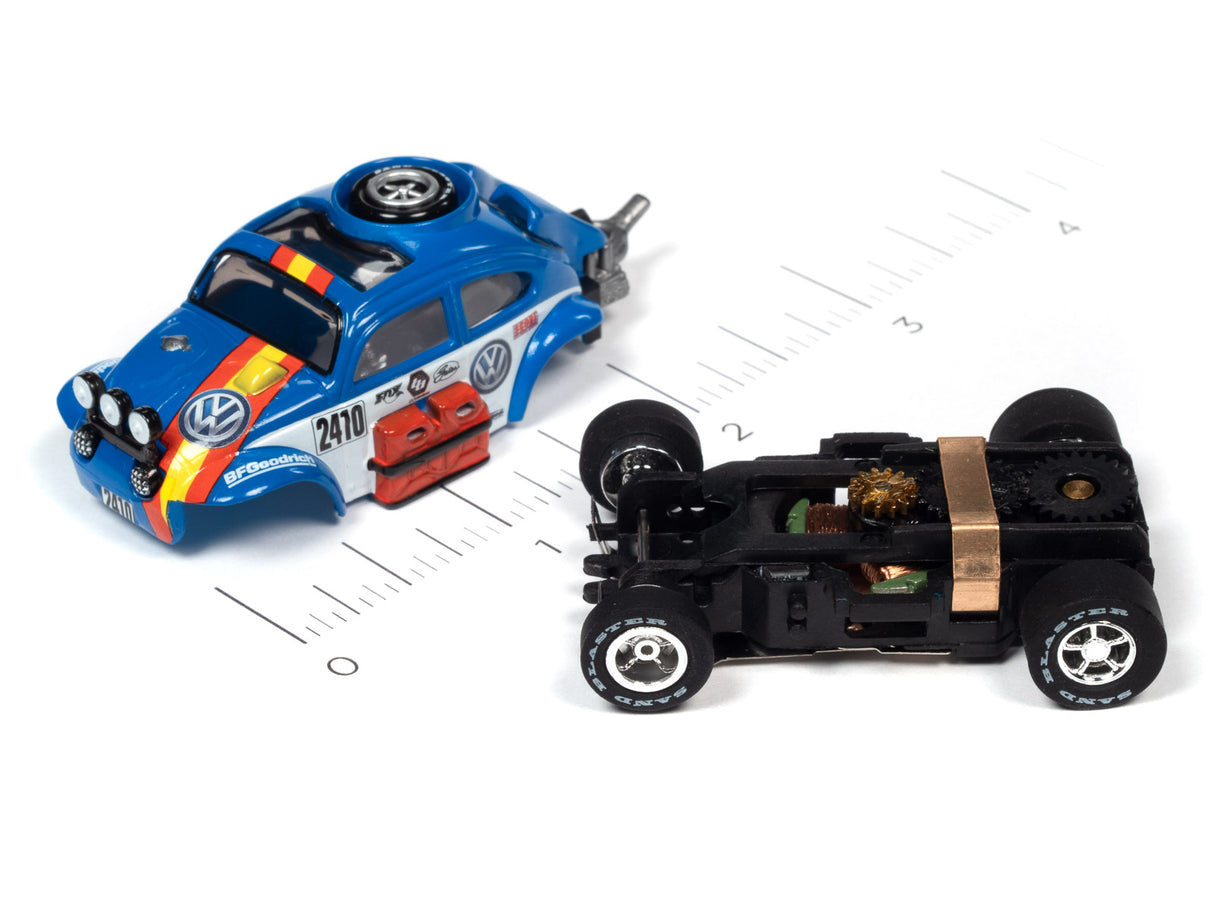 Blue and black slot car next to a black, open-frame race car for Auto World SC380