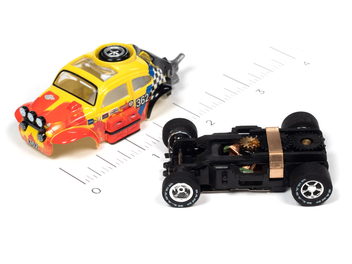 Yellow and red race car and black race car on a ruler for Auto World SC380