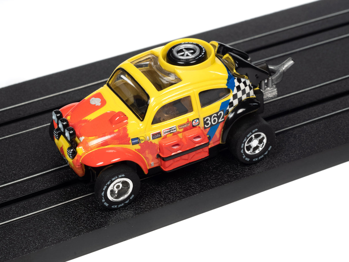 Yellow and red rally car toy on a black track for Auto World SC380