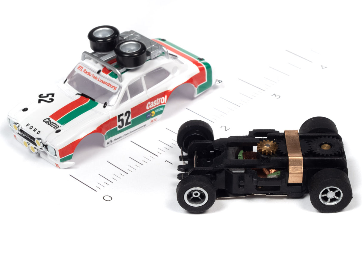 White and red race car model with visible motor and wheels on a ruler for Auto World SC380