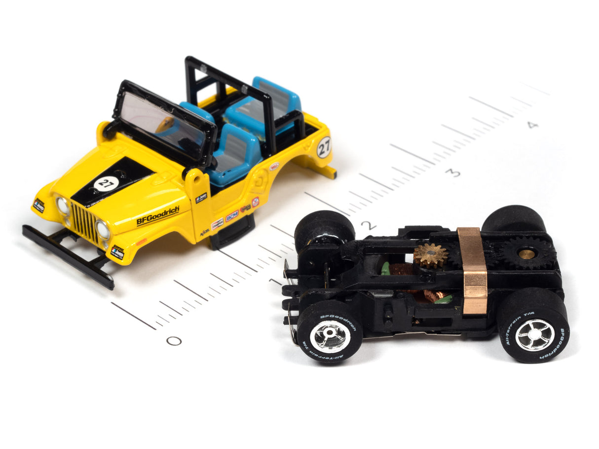 Yellow and black race car toy next to a black, open-frame race car toy for Auto World SC380