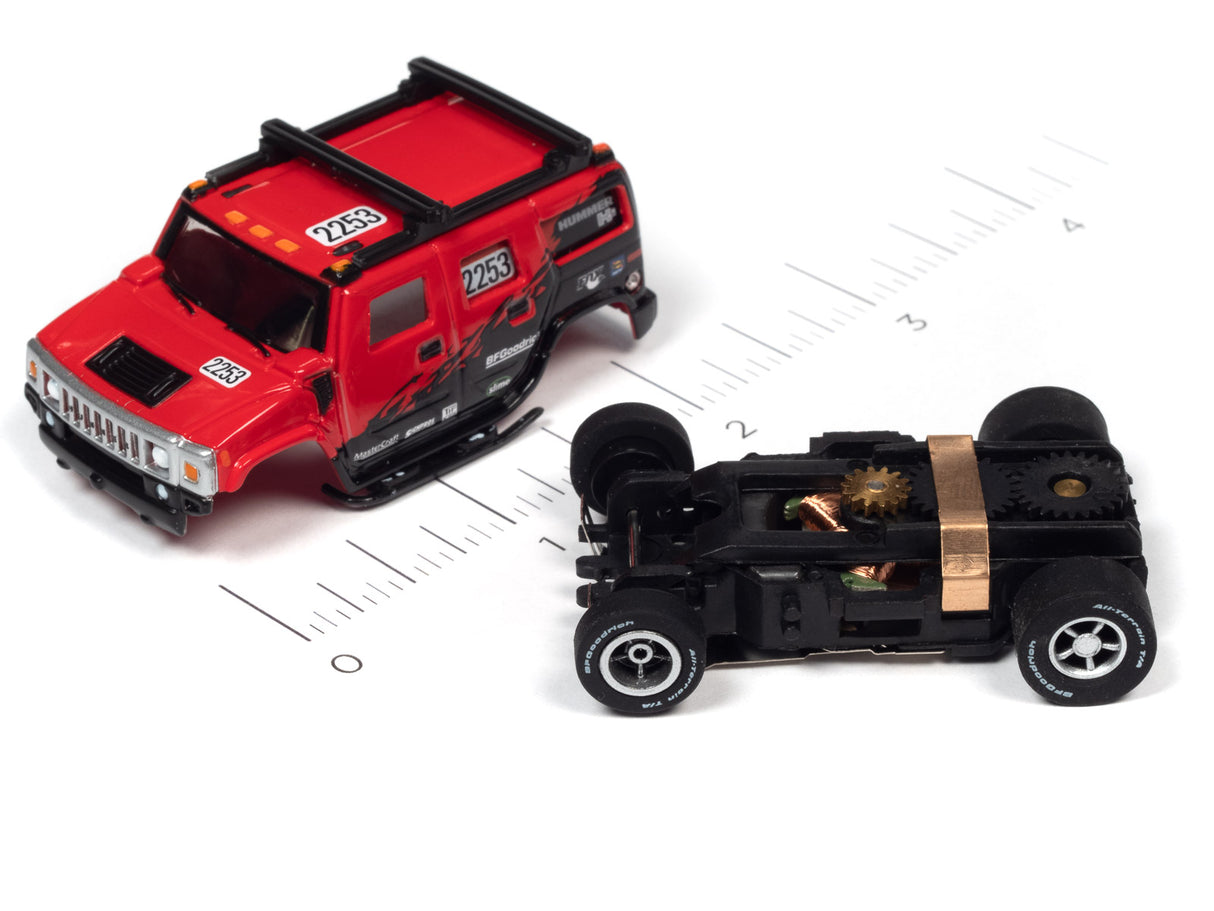 Red and black remote-controlled race cars on a ruler scale for Auto World SC380