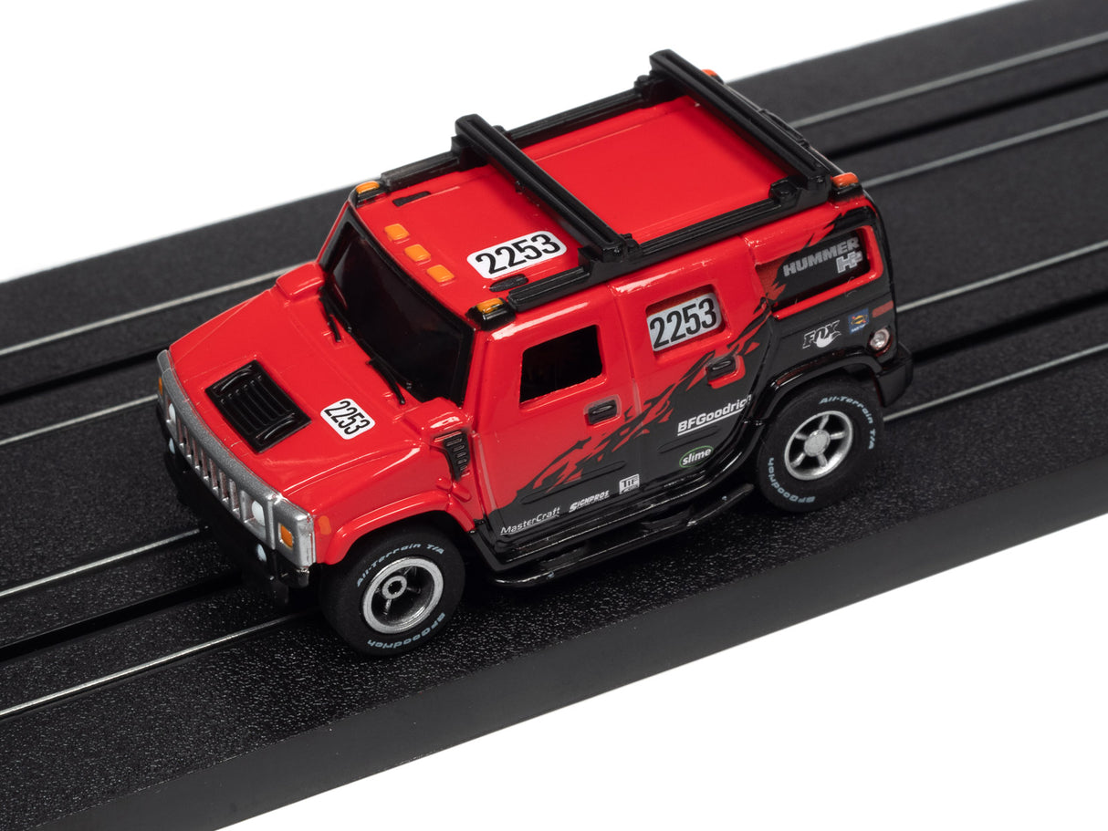 Red slot car truck on a black track for Auto World SC380