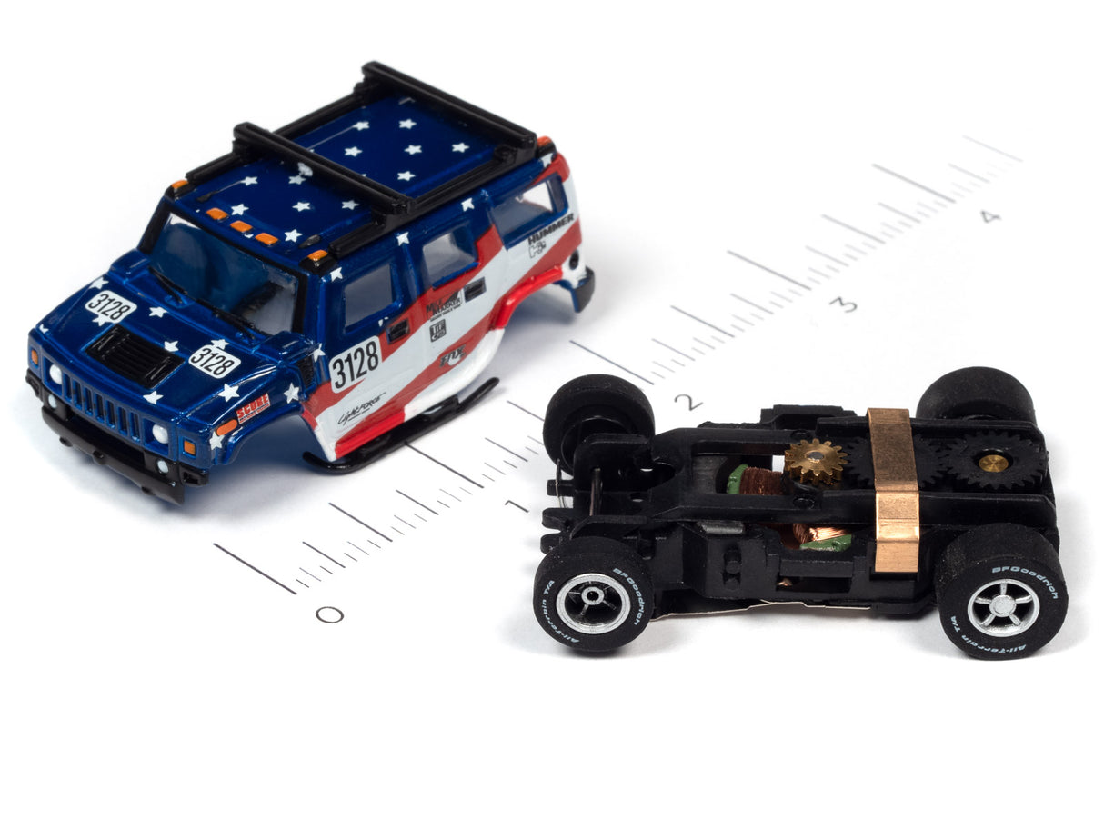 Blue and white toy car next to its disassembled chassis on a ruler for Auto World SC380