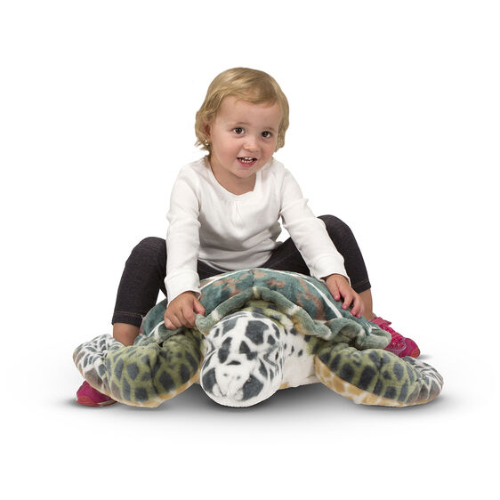 Child with large stuffed sea turtle toy for Melissa and Doug 2127