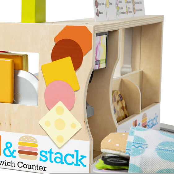 Wooden play food counter with pretend bread, cheese, and sandwich accessories for Melissa and Doug 31650