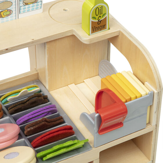 Toy sandwich counter with play food accessories and condiment bottles for Melissa and Doug 31650
