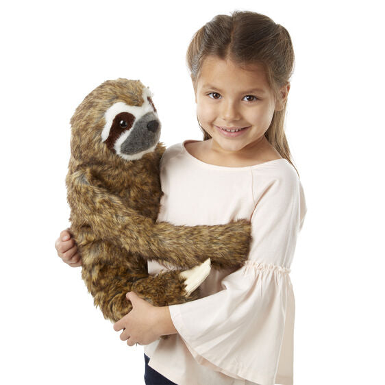 Girl holding a stuffed sloth toy against a white background for Melissa and Doug 8088