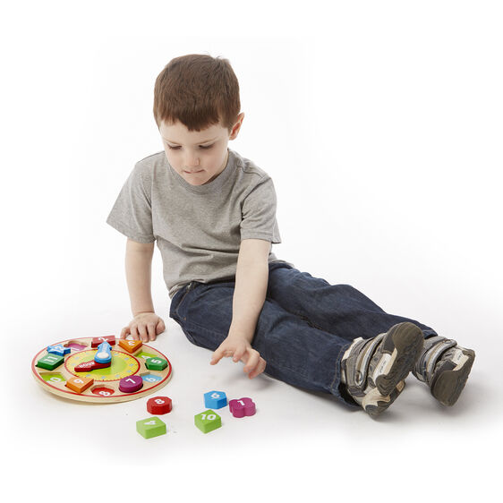 Boy plays with a shape sorting clock toy, learning colors and numbers for Melissa and Doug 8593