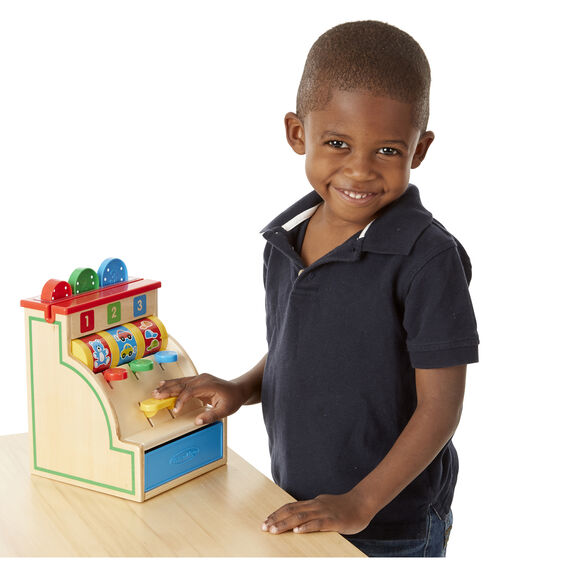 Boy plays with a colorful, wooden cash register toy for Melissa and Doug 3378