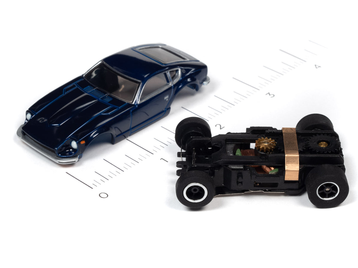 Blue race car and black slot car on a ruler for scale for Auto World SRS342