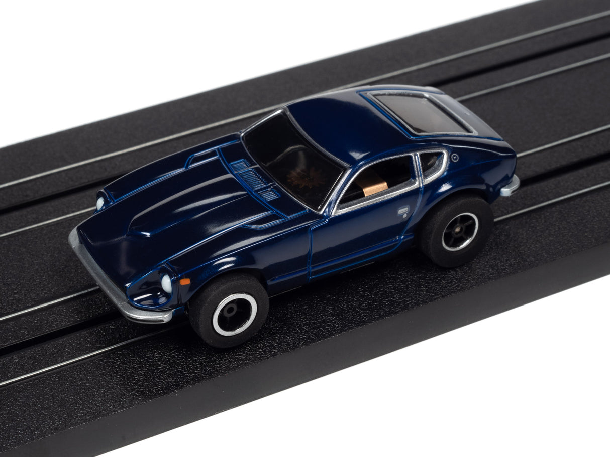 Blue slot car race car on a black slot track for Auto World SRS342