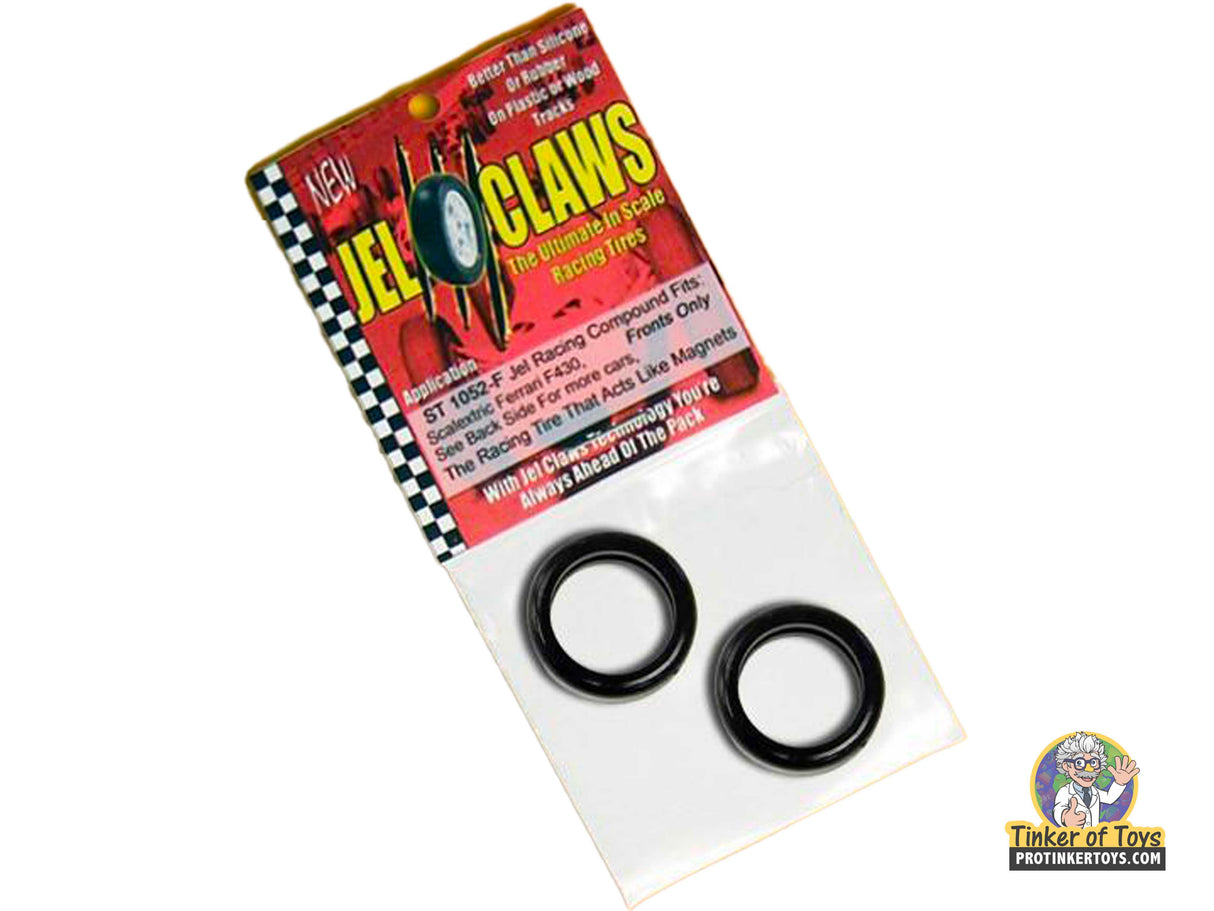 Two black, circular model car tires on a branded card for 1:32 ST 1052-F