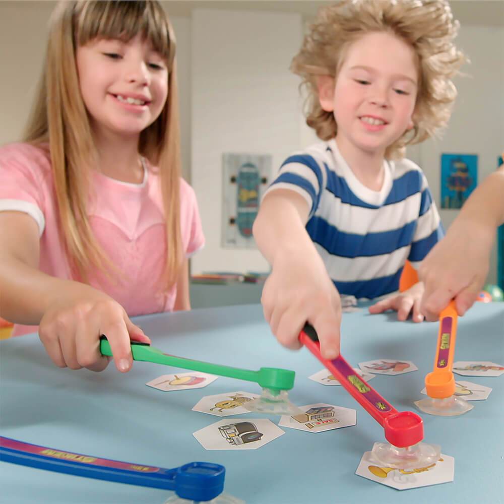 Kids playing with colorful slap sticks on a light blue table for Zing ZG666