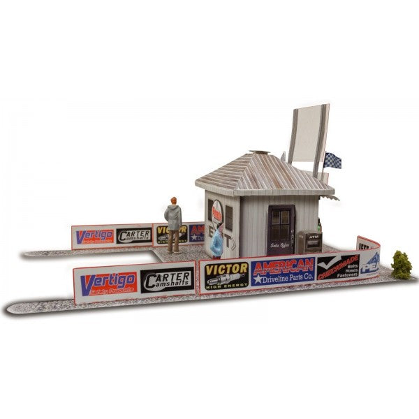 Model kit of a ticket and gate entrance with small figures and signs for Innovative Hobby Supply BK4806