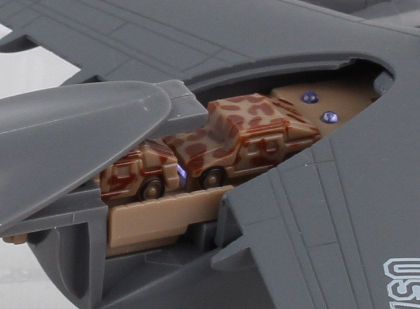 Toy airplane with a brown, spotted vehicle pulling out for Daron TM9020