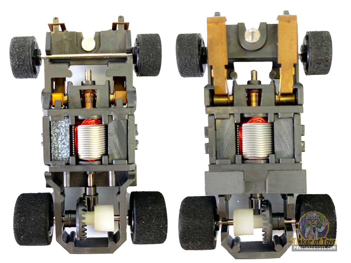 Two black chassis kits with wheels and visible internal components for Tyco