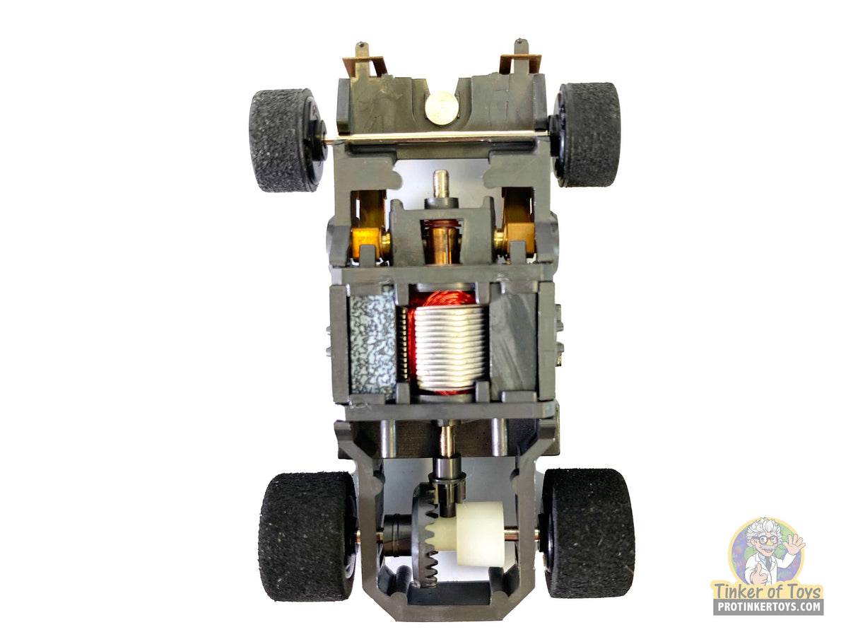 Robot chassis with wheels and visible motor components for Tyco