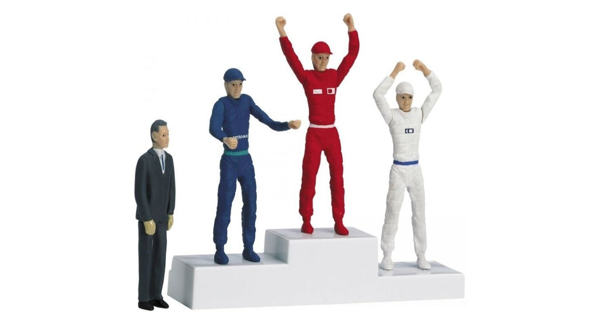 Figurines on a winner's podium: a standing man, two celebrating athletes, and a third athlete for Carrera 21121