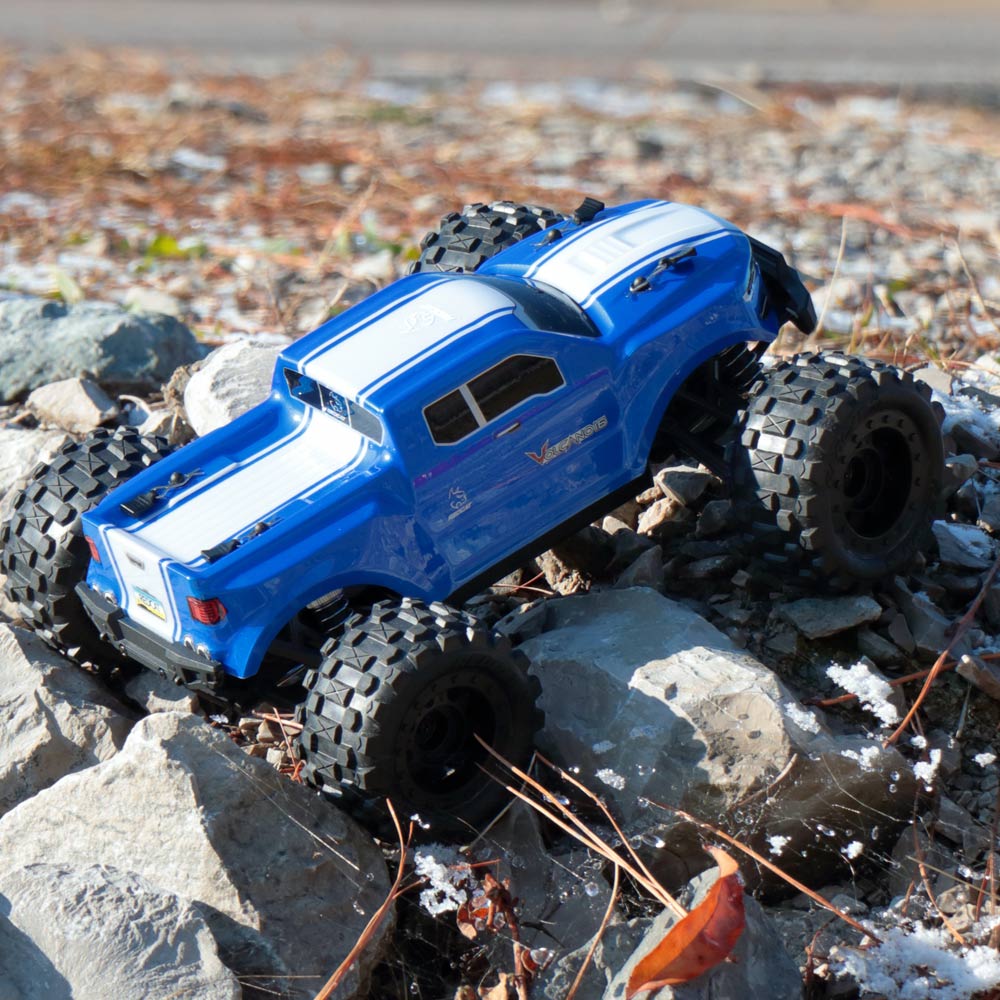 Blue monster truck toy on rocks with dirt and leaves for RedCAT VOLCANO16