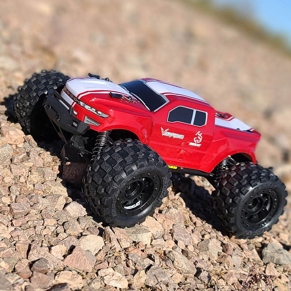 Red monster truck on rocks with large, knobby tires for RedCAT VOLCANO16