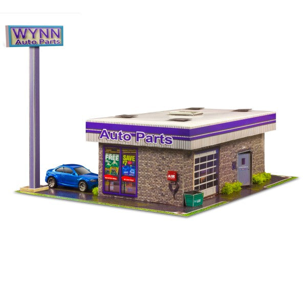 Model kit of an auto parts store with a blue car in front for Innovative Hobby Supply BK6435