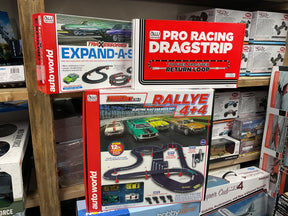 Toy car track and race set assortment on wooden shelving for Bargain 15