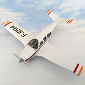 Model airplane, white with orange trim, featuring "F2J84" on the tail for HotWings 13114