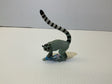 Grey lemur toy with long, striped tail standing on a white surface for Mamejo MAJ55028, front view