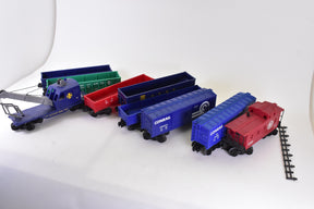 Assortment of blue and red O gauge train cars and engine for Lionel