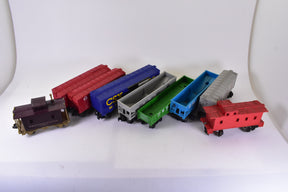 Assortment of O gauge train cars: locomotive, boxcars, and freight cars for Lionel
