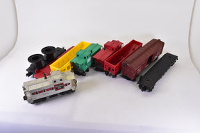 Assortment of O gauge train cars: locomotive, freight, and passenger cars for Lionel