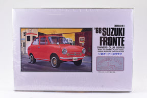 Red 1968 Suzuki Fronte model kit box art showing the car in a street scene for Arii 51003