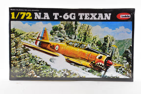 Scale model kit box art: T-6 Texan airplane flying over rocky terrain for Lodela