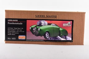 Green, retro car model kit box art featuring a classic, spooky vehicle design for Testors Frankenstude 1/32 Scale