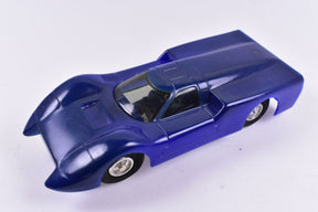 Blue slot car model, low angle view, showing detailed body and wheels for Eldon Slot Car 1350-12