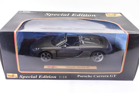Black 1:18 scale model of a Porsche Carrera GT in its box for Maisto 46629