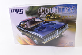 Box art for a 1/25 scale model kit of a 1969 Dodge Charger R/T for MPC MPC878M