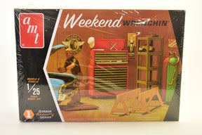 Model kit box art showing tools and a figure working on a car for AMT