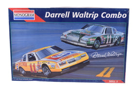 Two vintage race cars, Darrell Waltrip models, on a blue background for Monogram 6391