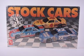 Three vintage slot car kits: 43, 4, and 22 for AMT/ERTL