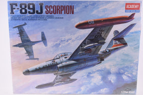 Model kit box art: F-89J Scorpion jet fighter in flight against a blue sky for Academy 1628