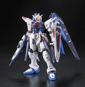 Freedom Gundam model kit, white, blue, and red, standing in a dynamic pose for Bandai 2143383