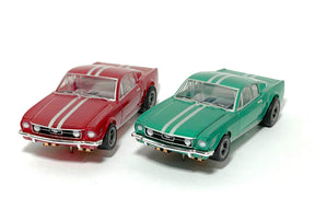 Two slot car Mustang cars, one red and one green, displayed side-by-side for AFX/Racemasters 22085
