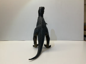 Dinosaur model standing on a white surface, tail extended for Mamejo MAJ32000, front view