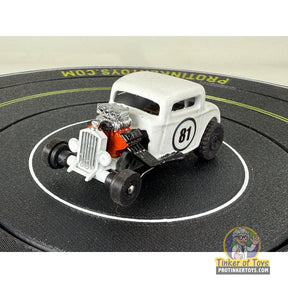White hot rod car with number 81 on a black circular surface for Extreme 3D Customs Extreme 3D Customs