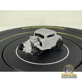 Unpainted 3D printed coupe hot rod with slick tires on a black surface for Extreme 3D Customs Extreme 3D Customs, front view